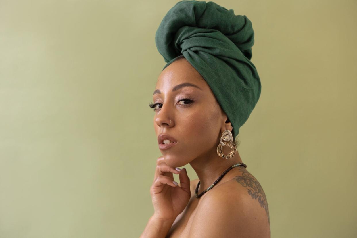 black woman wearing headscarf with light makeup