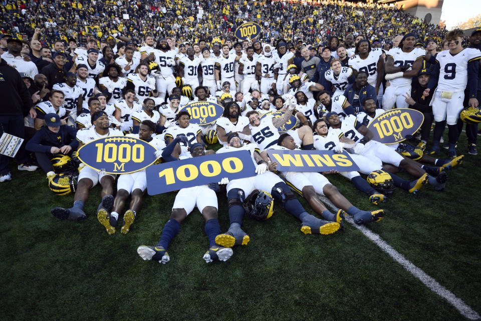 Michigan poses for photographers after an NCAA college football game that earned them their 1,000 win in school history, Saturday, Nov. 18, 2023, in College Park, Md. Michigan won 31-24. (AP Photo/Nick Wass)