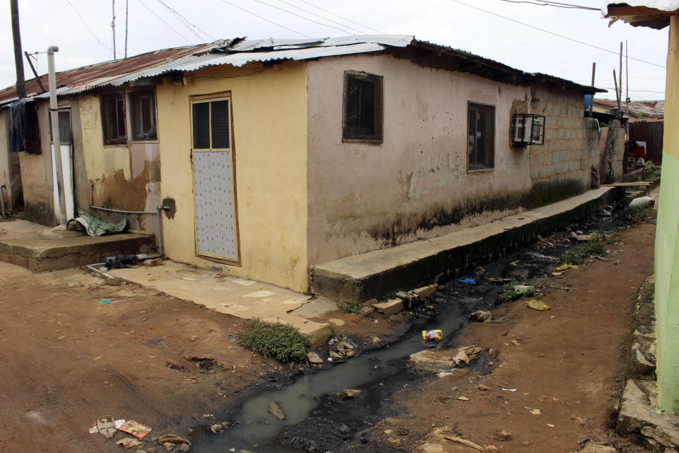 Sewage water runs past a house in Abuja, Nigeria, Friday, Sept. 3, 2021. Nigeria is seeing one of its worst cholera outbreaks in years, with more than 2,300 people dying from suspected cases as the West African nation struggles to deal with multiple disease outbreaks. This year’s outbreak which is associated with a higher case fatality rate than the previous four years is also worsened by what many consider to be a bigger priority for state governments: the COVID-19 pandemic. (AP Photo/Gbemiga Olamikan)