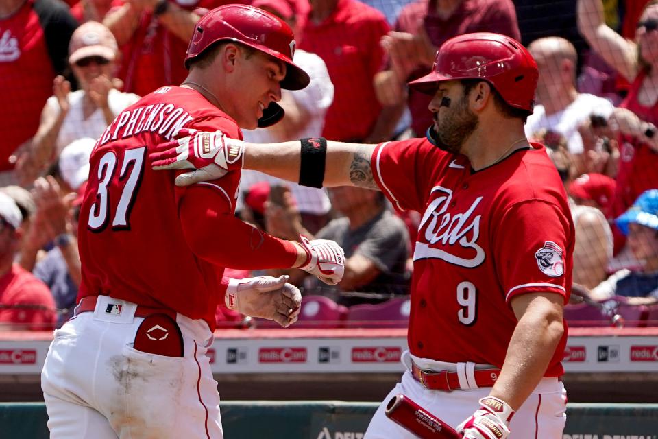 Cincinnati Reds catcher Tyler Stephenson (37) is congratulated by Cincinnati Reds first baseman Mike Moustakas (9) after hitting a two-run home run during the third inning of a baseball game against the Tampa Bay Rays, Sunday, July 10, 2022, at Great American Ball Park in Cincinnati.