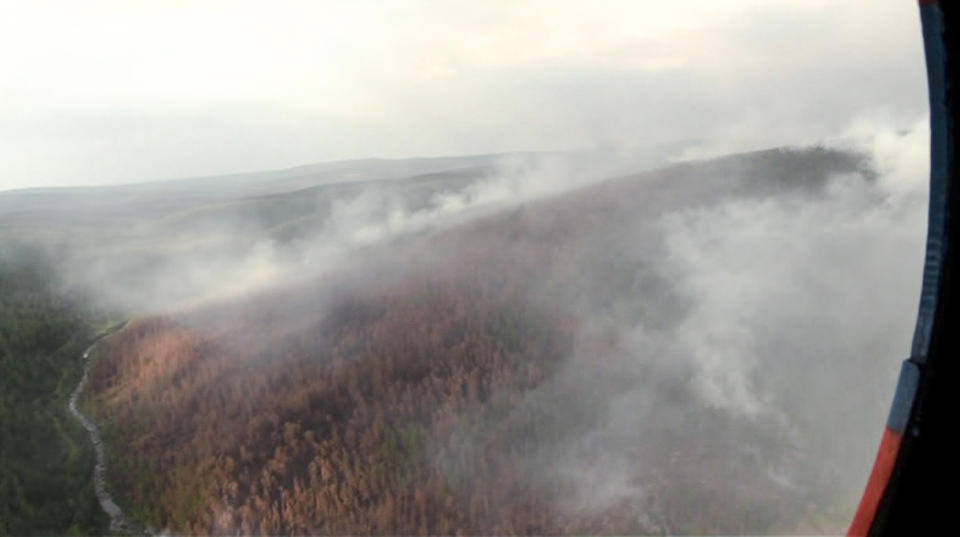 This image made from video provided by RU-RTR Russian television channel shows a view of a forest fire in the Boguchansky district of the Krasnoyarsk region, Russia Far East, Wednesday, July 31, 2019. Russian President Vladimir Putin has ordered Russia's military to join efforts to fight forest fires that have engulfed nearly 30,000 square kilometers (11,580 sq. miles) of territory in Siberia and the Russian Far East. (RU-RTR Russian Television via AP)