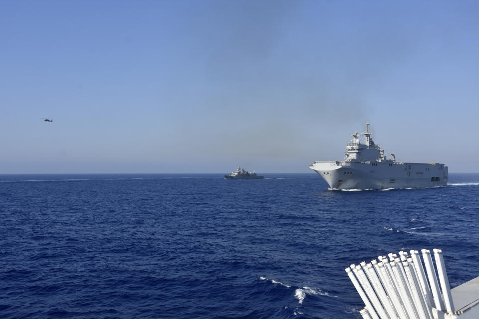 This photo provided Friday Aug.14, 2020 by the French Defense Ministry shows the French Tonnerre helicopter carrier, right, escorted by Greek and French military vessels during a maritime exercise in the Eastern Mediterranean, Thursday, Aug. 13, 2020. Greece's prime minister warmly thanked France Thursday for boosting its military presence in the eastern Mediterranean, where Greek and Turkish warships are closely shadowing each other over a Turkish energy exploration bid in waters Athens claims as its own. (French Defense Ministry via AP)