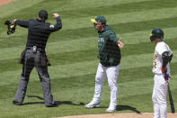 Home plate umpire Adam Hamari, left, ejects Oakland Athletics manager Mark Kotsay, center, during the fourth inning of a baseball game against the Chicago Cubs in Oakland, Calif., Wednesday, April 19, 2023. (AP Photo/Godofredo A. Vásquez)