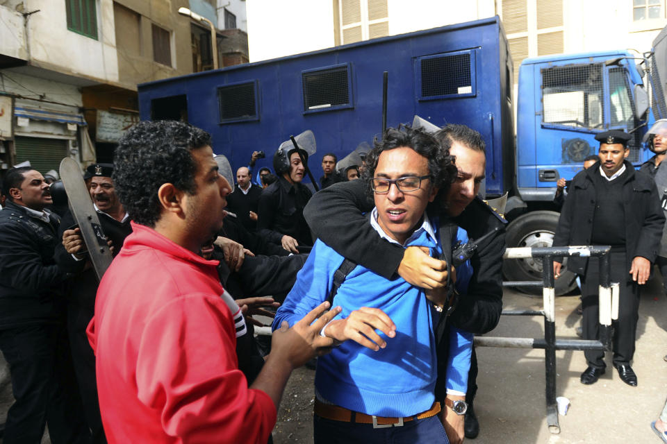 FILE - In this Saturday, Nov. 30, 2013 file photo, a protester is detained near a Cairo court where supporters of the April 6 youth group gathered to condemn the detention of 24 activists arrested Tuesday while taking part in a protest that was not authorized by authorities, in Cairo. Egypt. On Monday, April 7, 2014, an Egyptian appeals court has upheld convictions and three-year sentences for three prominent activists — Ahmed Maher, Mohammed Adel and Ahmed Douma. The three were accused of violating a controversial new law on holding protests. The ruling is part of a crackdown by Egypt's military-backed government against the leaders of the 2011 uprising that toppled the regime of autocrat Hosni Mubarak. (AP Photo/Ahmed Omar, File)