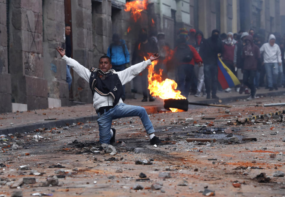 Protesters against the president stand off with police near the government palace during a transportation strike in Quito, Ecuador, Thursday, Oct. 3, 2019. Ecuador's president has declared a state of emergency to confront rowdy street protests and a nationwide transport strike over his decision to end government fuel subsidies and relax labor protections. (AP Photo/Dolores Ochoa)