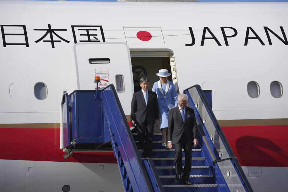 Emperor Naruhito, left, and Empress Masako walk down from their aircraft as they arrive at Stansted Airport, England, Saturday, June 22, 2024, ahead of a state visit. The state visit begins Tuesday, when King Charles III and Queen Camilla will formally welcome the Emperor and Empress before taking a ceremonial carriage ride to Buckingham Palace. (AP Photo/Kin Cheung)