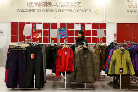 FILE PHOTO: An employee waits for customers at Sun Art Retail Group's Auchan hypermarket store in Beijing, China, November 9, 2015. REUTERS/Kim Kyung-Hoon/File Photo
