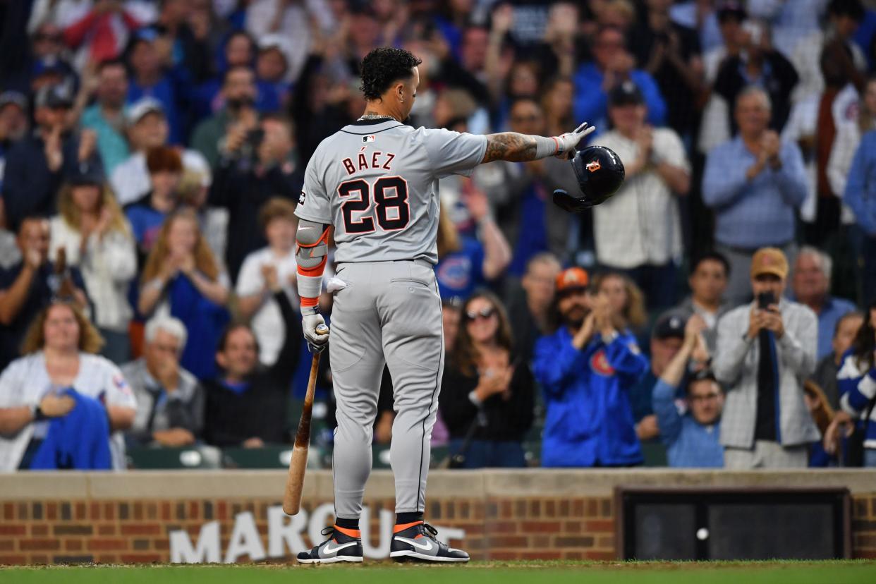 Detroit Tigers shortstop Javier Baez reacts and waves to the Chicago Cubs dugout during his standing ovation for his first game back at Wrigley Field during the second inning in a game on Tuesday, Aug. 20, 2024, in Chicago.