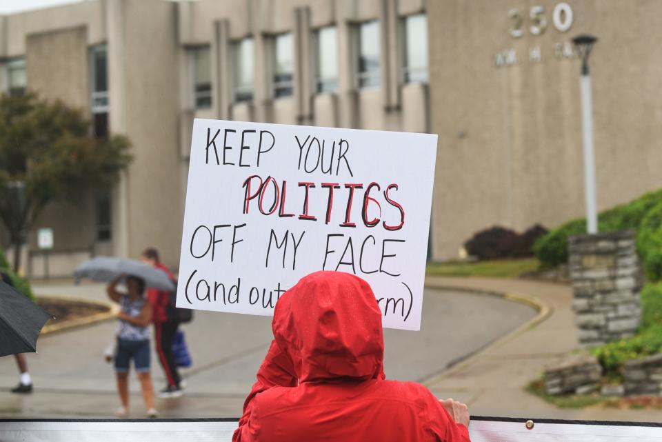 Protesters gather outside the Hamilton County Public Health building, displaying anti-mask signs to passing cars on William Howard Taft Road in the Cincinnati neighborhood of Corryville on Monday, Aug. 9, 2021.