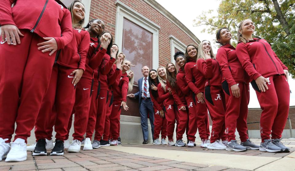 The University of Alabama honored SEC championship teams in men's basketball, softball and gymnastics Friday, Nov. 5, 2021, at the Sarah Patterson Champions Plaza. President Stuart Bell poses for a photo with the gymnastics team. [Staff Photo/Gary Cosby Jr.]