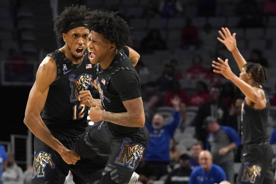 Memphis forward DeAndre Williams (12) and guard Kendric Davis (3) celebrate a play during the first half of an NCAA college basketball game against Houston in the finals of the American Athletic Conference Tournament, Sunday, March 12, 2023, in Fort Worth, Texas. (AP Photo/LM Otero)