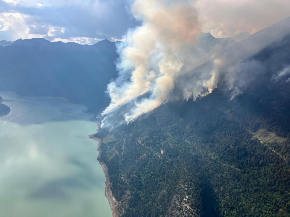 The Downton Lake wildfire is seen burning earlier in July. It was sparked by lightning on July 13, but a recent flare-up on Monday led to evacuation orders.