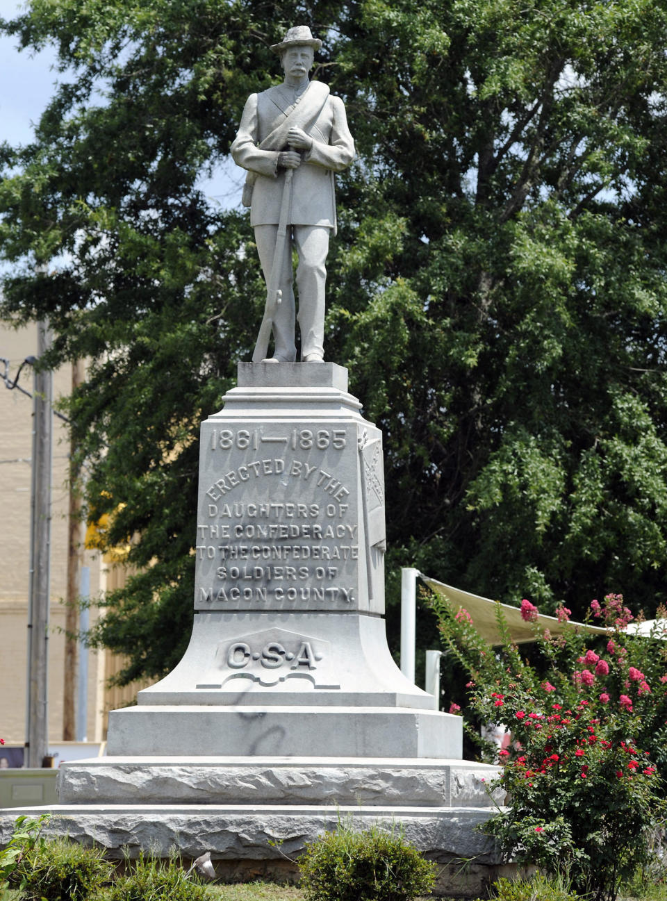 FILE - This Thursday, June 28, 2018 file photo shows a Confederate monument dedicated in 1909 standing in the middle of the square in Tuskegee, Ala.. Following nationwide protests over the police killing of George Floyd and an attack on the monument by vandals, the chairman of the Macon County Commission said officials will cover the memorial with a tarp and are looking for ways to remove it. (AP Photo/Jay Reeves, File)