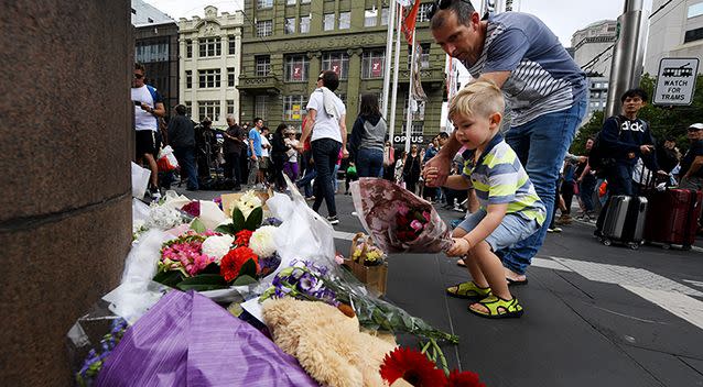 Flowers are left at the memorial site in Bourke Street. Photo: AAP