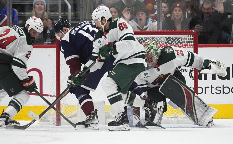 Colorado Avalanche right wing Valeri Nichushkin, second from left, scores in overtime as Minnesota Wild defenseman Zach Bogosian, center Frederick Gaudreau and goaltender Filip Gustavsson, from left, defend during an NHL hockey game Friday, March 8, 2024, in Denver. (AP Photo/David Zalubowski)