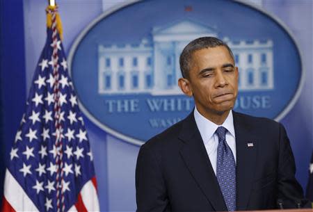 U.S. President Barack Obama pauses while speaking about the continuing government shutdown during a news conference in the White House Briefing Room in Washington, October 8, 2013. REUTERS/Kevin Lamarque