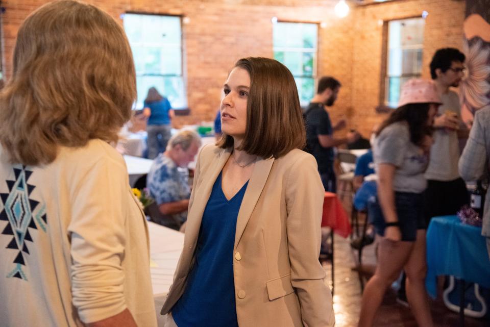 Danielle Hawk, Democratic candidate in Florida's 3rd Congressional District, talks with an supporter during an election night event at Flowspace in Gainesville on Aug. 23.