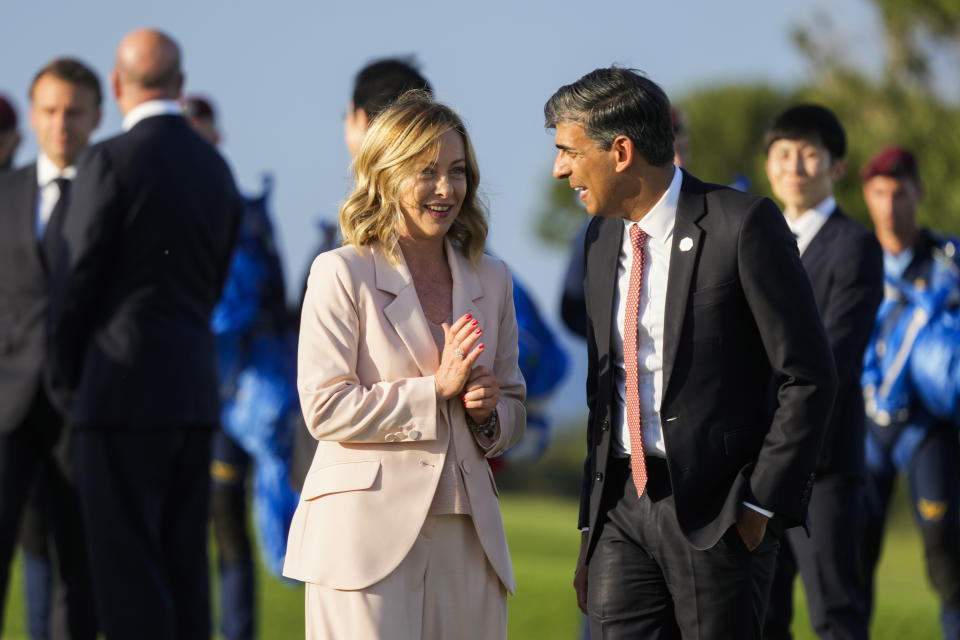 FILE -Italian Prime Minister Giorgia Meloni, left, talks to Britain's Prime Minister Rishi Sunak after watching a skydiving demo during the G7 world leaders summit at Borgo Egnazia, Italy, Thursday, June 13, 2024. Leaders of the Group of Seven leading industrialized nations are turning their attention to migration on the second day of their summit Friday. (AP Photo/Luca Bruno, File)