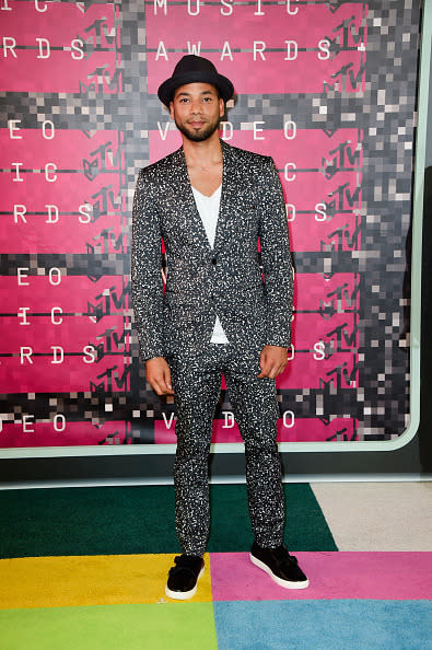 Jussie Smollett in a black and white suit.