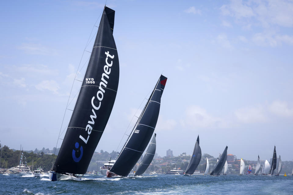LawConnect, left, leads the fleet during the start of the Sydney Hobart yacht race in Sydney, Tuesday, Dec. 26, 2023. The 630-nautical mile race has more than 100 yachts starting in the race to the island state of Tasmania. (Salty Dog/CYCA via AP)