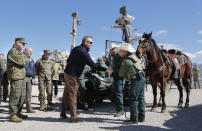 Acting Secretary of Defense Patrick Shanahan, center, greets Border Patrol Agents Carlos Lerma, second from the right, Moises Gonzalez, right, and the horse they use for patrols during a tour of the US-Mexico border at Santa Teresa Station in Sunland Park, N.M., Saturday, Feb. 23, 2019. On the far left is Joint Chiefs Chairman Gen. Joseph Dunford. Top defense officials toured sections of the U.S.-Mexico border Saturday to see how the military could reinforce efforts to block drug smuggling and other illegal activity, as the Pentagon weighs diverting billions of dollars for President Donald Trump's border wall. (AP Photo/Pablo Martinez Monsivais)