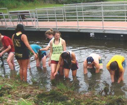 May 18, 2012. USC Environmental Studies students removing aquatic invasive algae from Masso Reservoir on Guam. Photo by author.