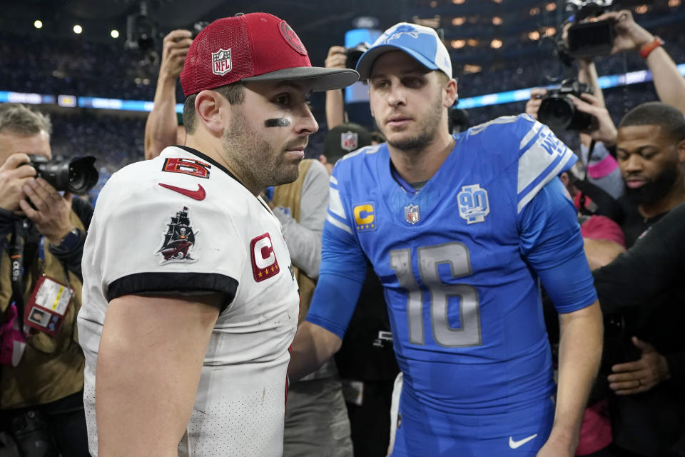 Tampa Bay Buccaneers quarterback Baker Mayfield, left, and Detroit Lions quarterback Jared Goff (16) meet on the field following an NFL football NFC divisional playoff game, Sunday, Jan. 21, 2024, in Detroit. The Lions won 31-23. (AP Photo/Carlos Osorio)