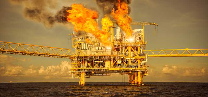 An offshore oil platform on fire.