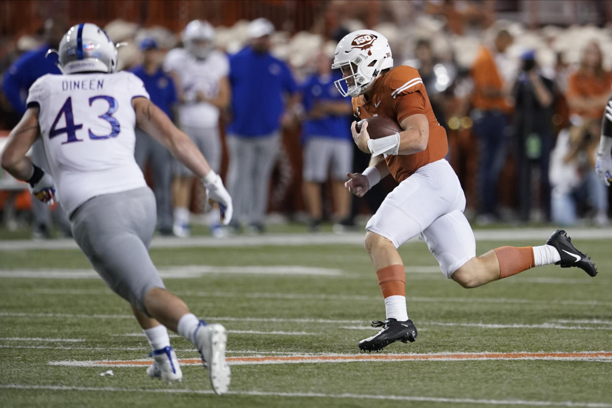 Texas' Sam Ehlinger (11) scrambles during the first half of an NCAA college football game against Kansas in Austin, Texas, Saturday, Oct. 19, 2019. (AP Photo/Chuck Burton)