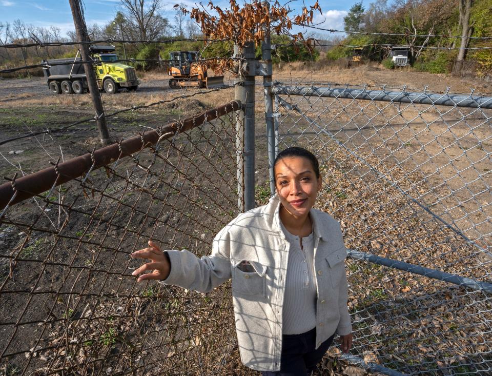 Kaila Austin shows the old John Hardrick property in the Norwood neighborhood. Austin, a neighborhood advocate, hopes the area will be cleaned up and used for a park.