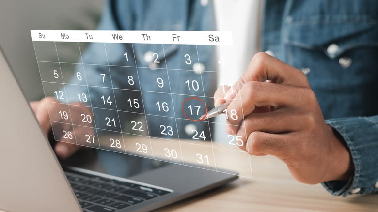 person using laptop calendar