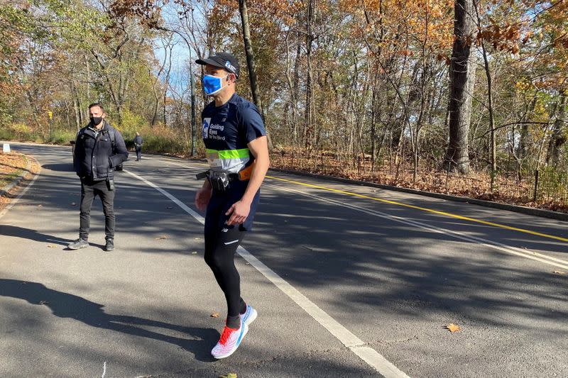 Thomas Panek, a blind runner and CEO of Guiding Eyes for the Blind, gets ready for a 5K run in Central Park where he will use Google's "Guideline" app instead of help from a human or guide dog, in New York