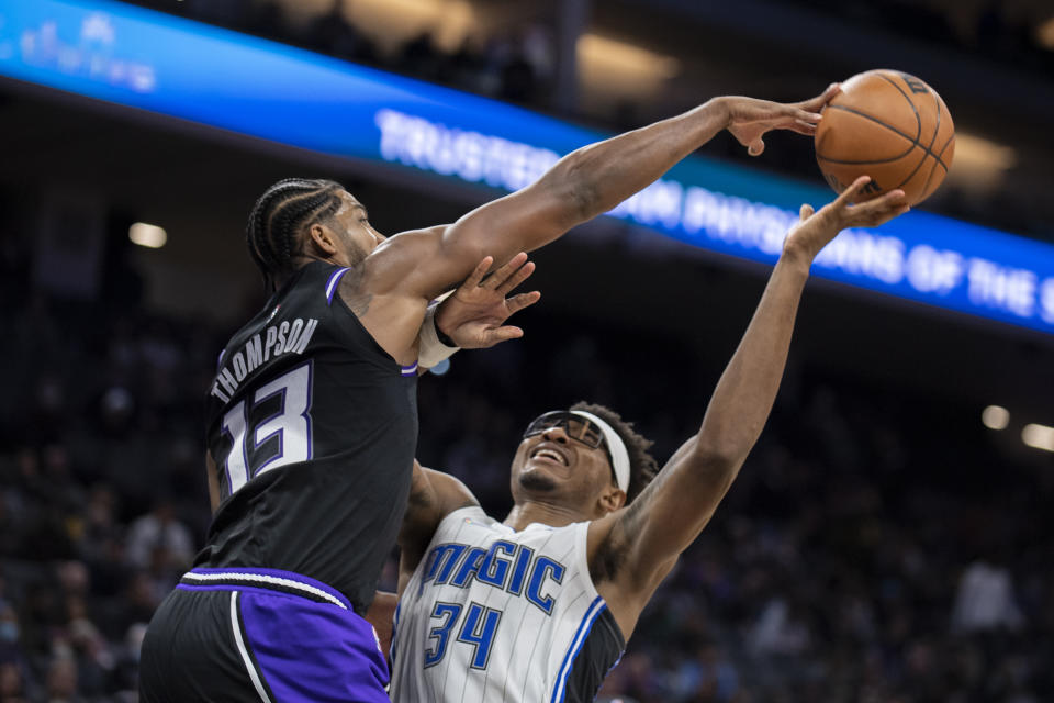 Sacramento Kings center Tristan Thompson (13) blocks the shot of Orlando Magic center Wendell Carter Jr. (34) during the second half of an NBA basketball game in Sacramento, Calif., Wednesday, Dec. 8, 2021. (AP Photo/Jose Luis villegas)