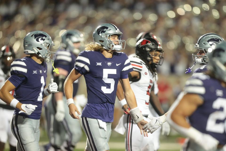 Kansas State freshman quarterback <a class="link " href="https://sports.yahoo.com/ncaaf/players/404434" data-i13n="sec:content-canvas;subsec:anchor_text;elm:context_link" data-ylk="slk:Avery Johnson;sec:content-canvas;subsec:anchor_text;elm:context_link;itc:0">Avery Johnson</a> (5) is applauded by teammates after scoring a touchdown in the fourth quarter of Saturday’s game against <a class="link " href="https://sports.yahoo.com/ncaaf/teams/se-missouri-st/" data-i13n="sec:content-canvas;subsec:anchor_text;elm:context_link" data-ylk="slk:Southeast Missouri State;sec:content-canvas;subsec:anchor_text;elm:context_link;itc:0">Southeast Missouri State</a> inside Bill Snyder Family Stadium.