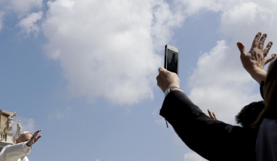 Pope Francis, left, waves as he is driven through the crowd after celebrating Easter Sunday Mass in St. Peter's Square at the Vatican, Sunday, April 16, 2017. (AP Photo/Gregorio Borgia)