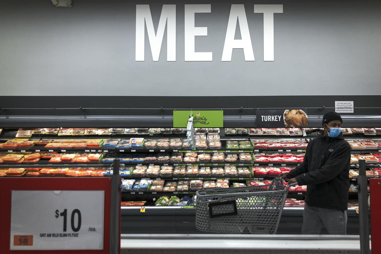 WASHINGTON, DC: A man shops in the meat section at a grocery store. (Photo by Drew Angerer/Getty Images)