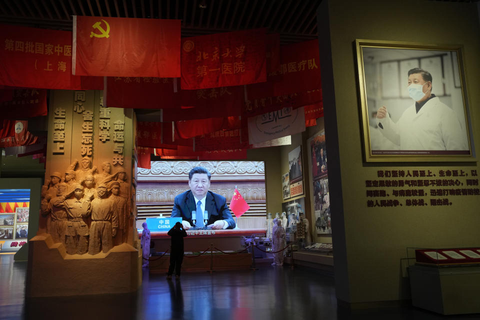 Chinese President Xi Jinping is seen on a screen near a photo showing him wearing a mask at an exhibition highlight China's fight against COVID-19 at the Museum of the Community Party of China in Beijing on Oct. 12, 2022. Xi is facing a challenge to his government's harsh "zero-COVID" policies, which have taken an economic and human toll. Small groups of residents staged protests during an extended lockdown in Shanghai earlier this year. In a rare political protest, someone hung banners from an elevated highway in Beijing this week attacking the policy and Xi himself. (AP Photo/Ng Han Guan)