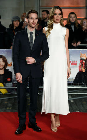 Luke Treadaway (L) poses with co-star Ruta Gedmintas as they arrive for the world premiere of "A Street Cat Named Bob" at The Curzon Mayfair in London, Britain November 3, 2016. REUTERS/Dylan Martinez
