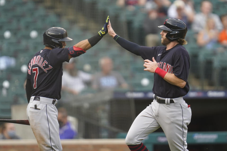 Cleveland Indians' Owen Miller, right, celebrates scoring with Cesar Hernandez (7) in the third inning of a baseball game against the Detroit Tigers in Detroit, Monday, May 24, 2021. (AP Photo/Paul Sancya)