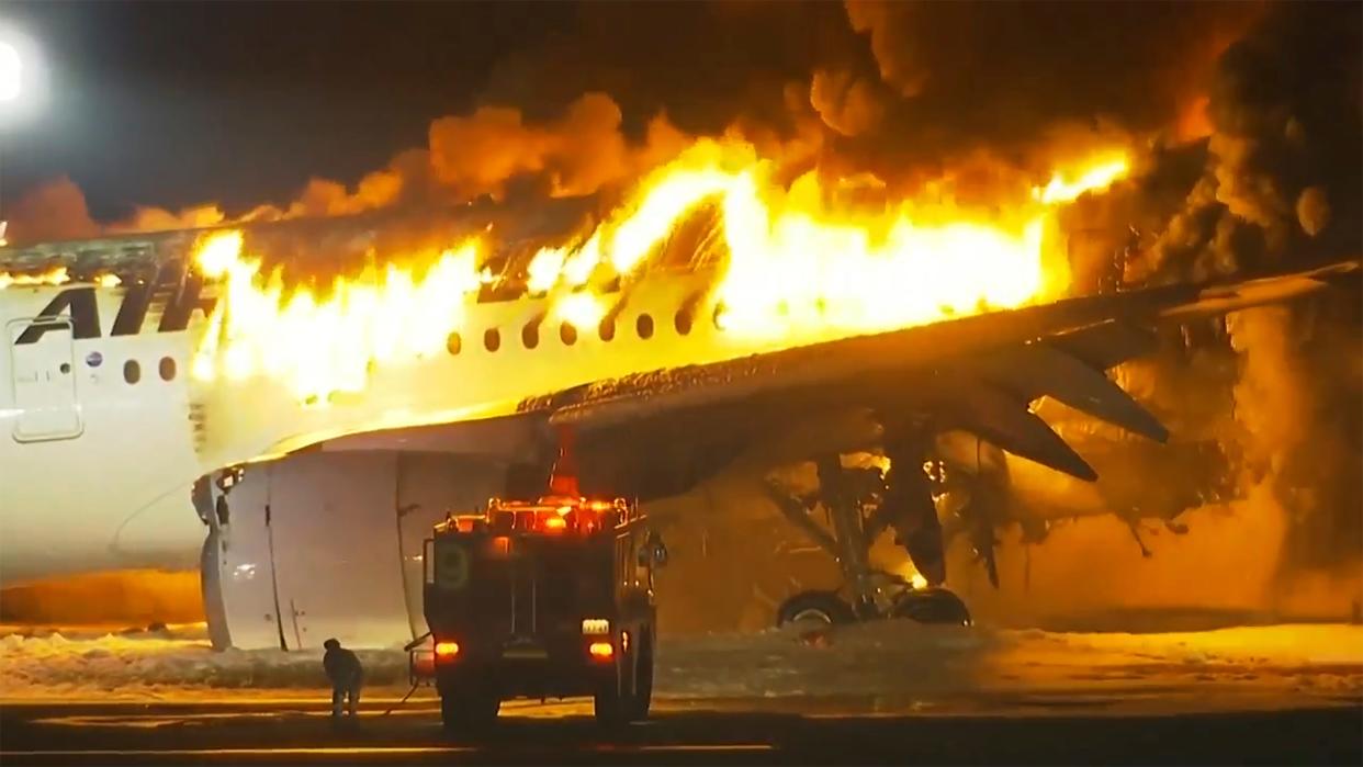 In this image made from video, a Japan Airlines plane is on fire on the runway of Haneda airport on Tuesday, Jan. 2, 2024 in Tokyo, Japan.
