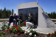 John Williams, of Peru, Ind., left, and his sisters, Maria McCauley, of Branson, Mo., center, and Susie Linale, of Omaha, Neb., pose at a monument to honor the military passengers of Flying Tiger Line Flight 739, Saturday, May 15, 2021, in Columbia Falls, Maine. Their father, SFC Albert Williams, Jr., was among those killed on the secret mission to Vietnam in 1962. (AP Photo/Robert F. Bukaty)