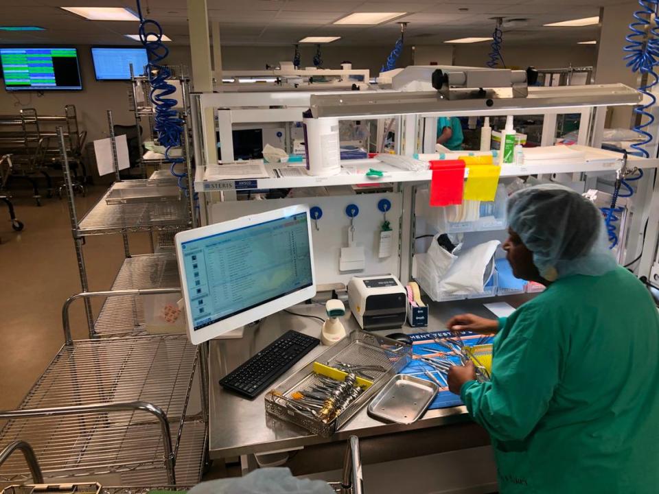 An employee with the sterile processing department at Saint Luke’s Hospital of Kansas City inspects instruments as they are cleaned before being used in operating rooms on Tuesday, Oct. 17, 2023.