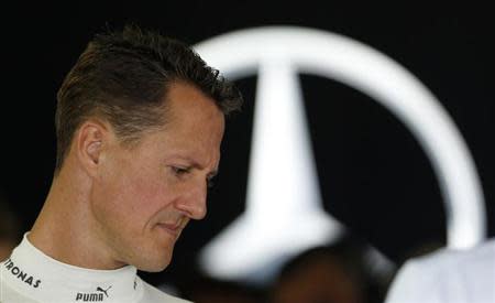 Mercedes Formula One driver Michael Schumacher of Germany stands inside his team garage during the first practice session of the Japanese F1 Grand Prix at the Suzuka circuit October 5, 2012. REUTERS/Kim Kyung-Hoon