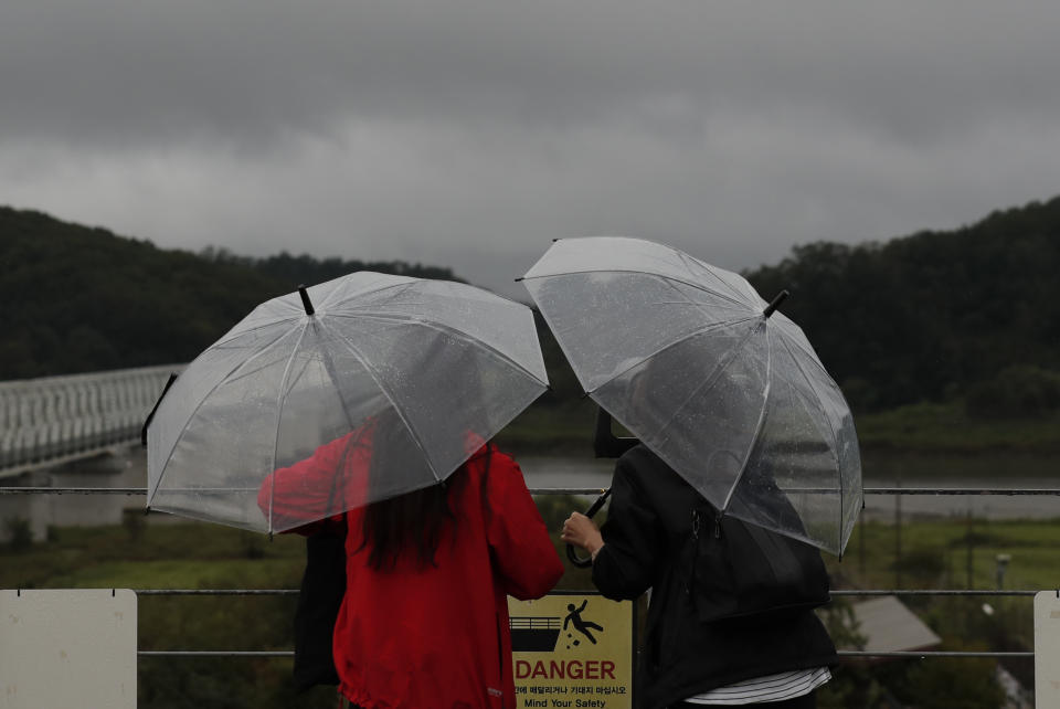 Visitors use binoculars to see the North side at the Imjingak Pavilion in Paju, South Korea, Tuesday, Sept. 10, 2019. North Korea launched two projectiles toward the sea on Tuesday, South Korea's military said, hours after the North offered to resume nuclear diplomacy with the United States but warned its dealings with Washington may end without new U.S. proposals. (AP Photo/Lee Jin-man)