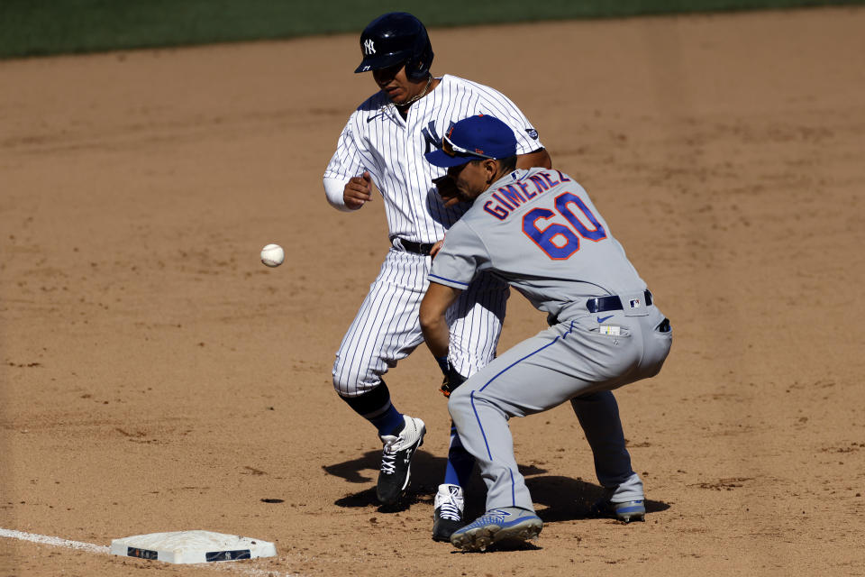 New York Mets shortstop Andres Gimenez (60) can't handle the throw as New York Yankees' Thairo Estrada is safe at third base during the seventh inning of the first baseball game of a doubleheader, Sunday, Aug. 30, 2020, in New York. The Yankees won 8-7. (AP Photo/Adam Hunger)