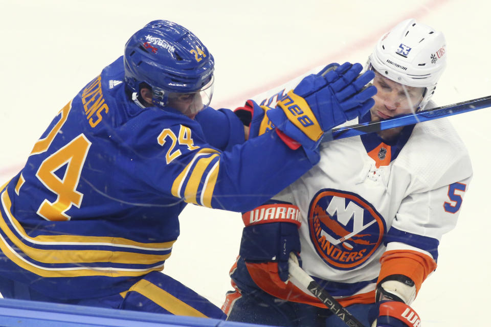 Buffalo Sabres forward Dylan Cozens (24) and New York Islanders forward Casey Cizikas (53) collide during the first period of an NHL hockey game, Monday, May 3, 2021, in Buffalo, N.Y. (AP Photo/Jeffrey T. Barnes)