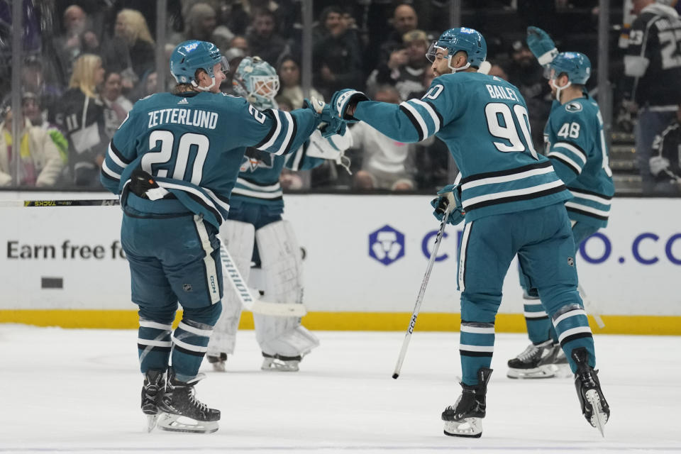 San Jose Sharks left wing Fabian Zetterlund (20) celebrates with right wing Justin Bailey (90) after scoring in a shootout during an NHL hockey game against the Los Angeles Kings Monday, Jan. 22, 2024, in Los Angeles. (AP Photo/Ashley Landis)