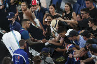 Australia's Nick Kyrgios sign autograph to fans after defeating France's Ugo Humbert during their second round match at the Australian Open tennis championship in Melbourne, Australia, Wednesday, Feb. 10, 2021. (AP Photo/Hamish Blair)