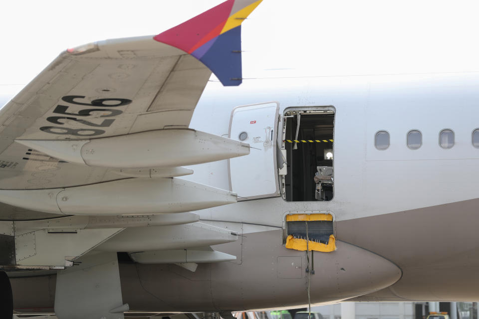 An opened door of an Asiana Airlines plane is seen at Daegu International Airport in Daegu on May 26, 2023, after it was manually opened by a passenger just 200 metres above the ground before landing causing some to have breathing difficulty but with no major injuries.