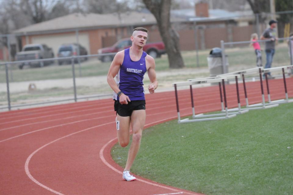 Southeast of Saline's Dylan Sprecker turns the corner during the 1,600-meter run of the Saline County Invitational Tuesday, March 29 2022 at Salina Stadium.